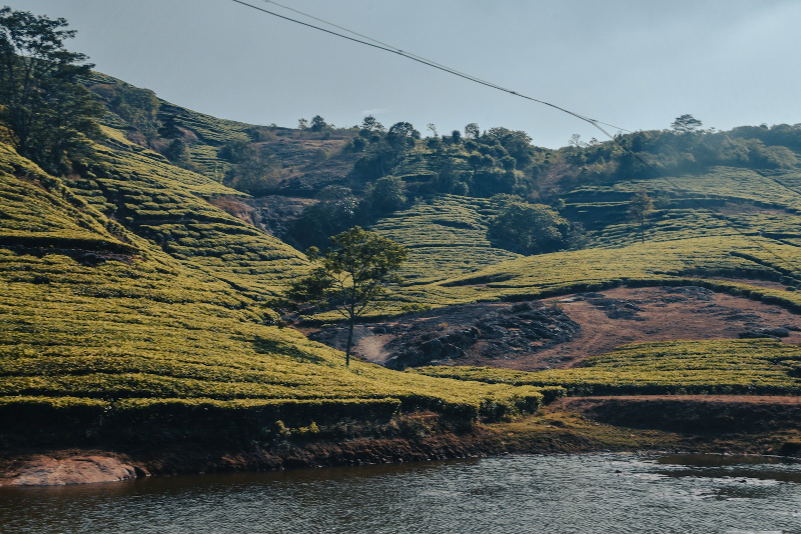 a river running through a lush green hillside